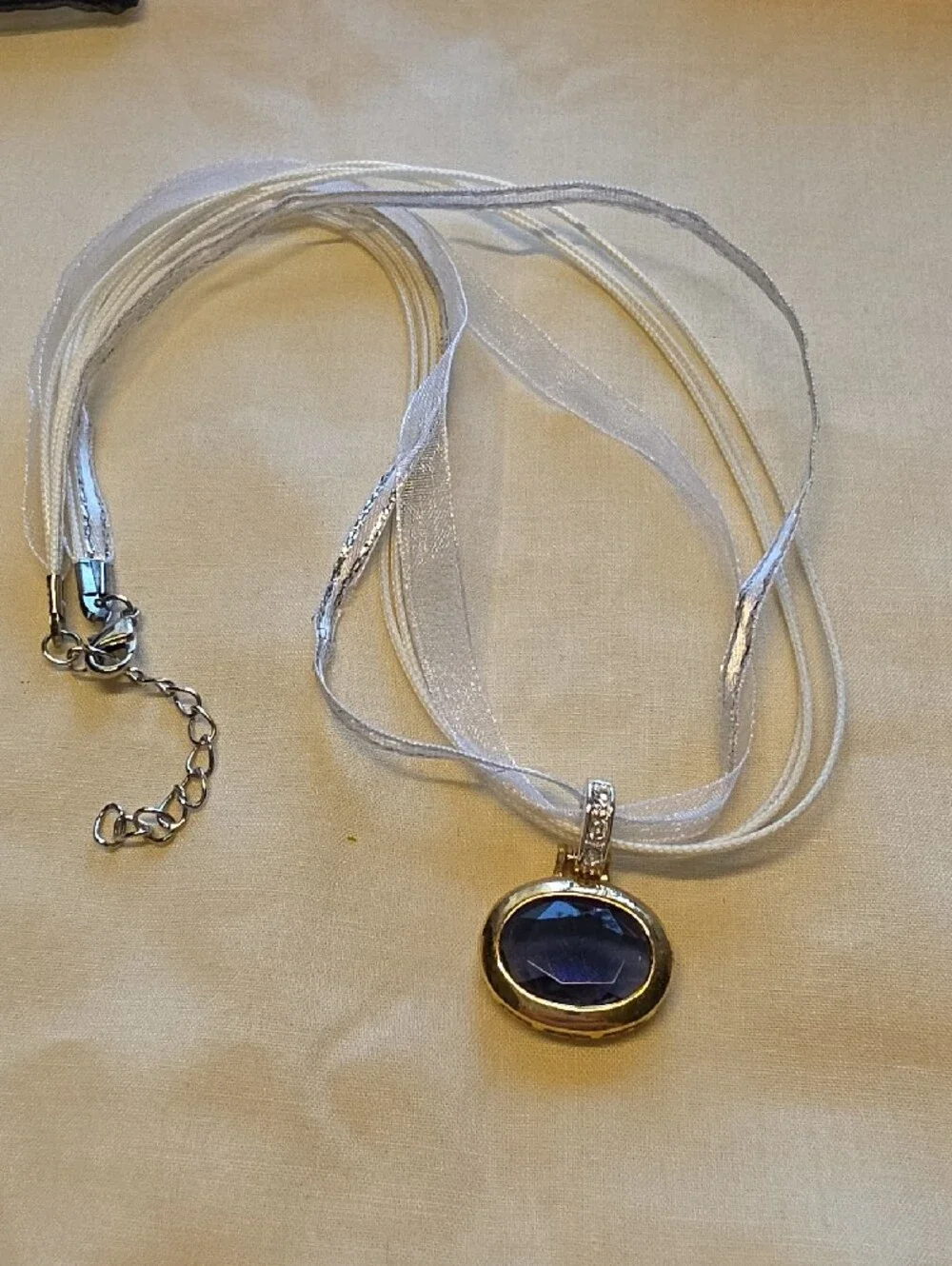 Silver Ribbon Necklace with Deep Blue Oval Gem Pendant